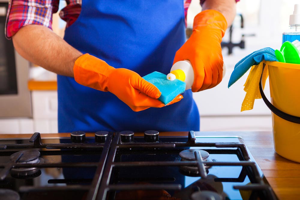 Man Cleaning Hob